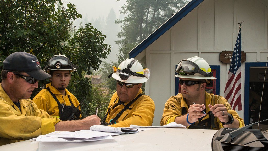 Fire crew reviewing plans together at a table