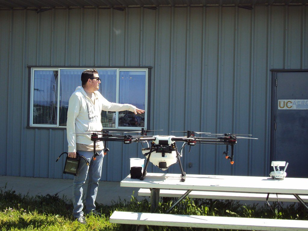 Instructor demonstrating a drone outside a training building